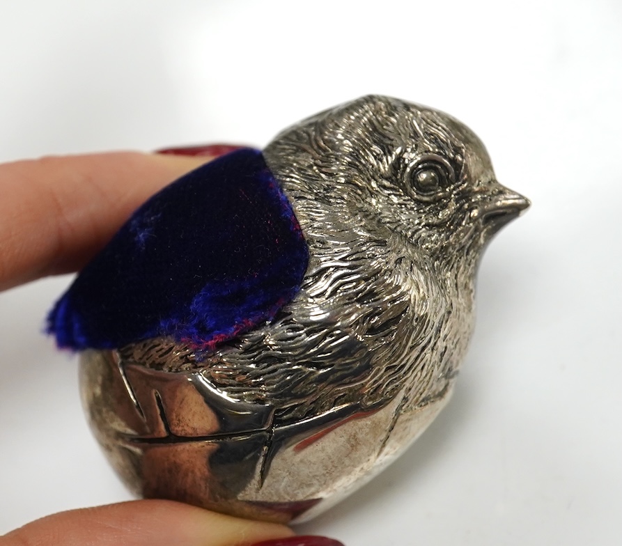 An unmarked white metal hatching chick pin cushion, height 44mm, an early Victorian coral and silver child's rattle by Joseph Wilmore (damaged), a fruit knife and sundry small boxes. Condition - poor to fair